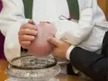A baby is baptized, a sacred ritual symbolizing new beginnings, as described in the Bible.