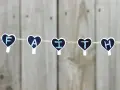 Five heart-shaped clothespins spell "FAITH" on a string, a reminder for prayers for children.
