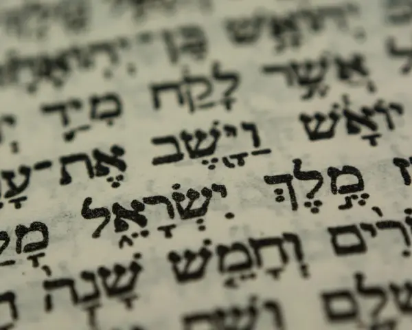 Close-up of Hebrew text on aged paper, hinting at the biblical meaning of Israel through ancient scripture.