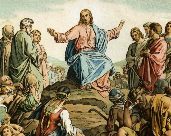 Jesus preaches the Beatitudes Catholic to a crowd gathered on a hillside, his arms outstretched in blessing.