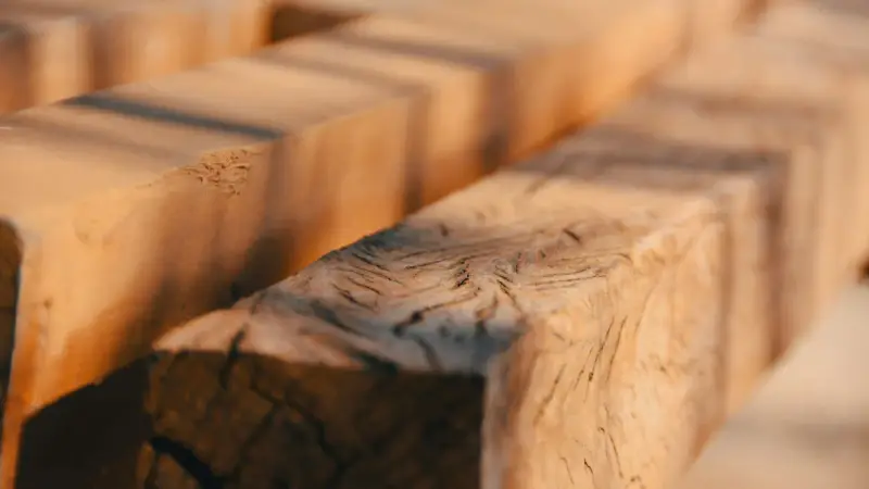 Close-up of rough-hewn wooden beams, evoking the question: was Jesus a carpenter?